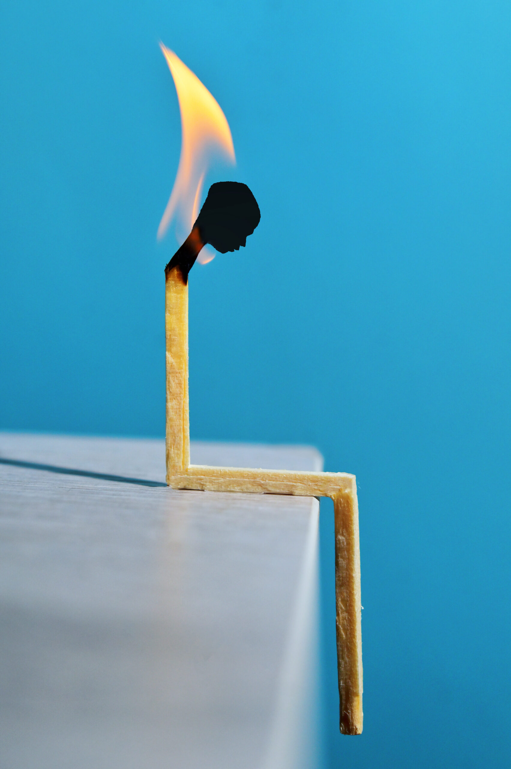 Burning match in image of a person indicating "burn out"